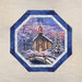 Mockup of a completed panel table topper in icy blue fabrics in a snow winter theme.