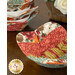 A closer look at the bowl cozies, demonstrating details on the red, orange, yellow, dusty teal, and cream fabrics of the cozies.