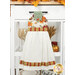 The completed hanging towel staged on a kitchen drawer, colored in cream, dusty teal, red, yellow, and orange fabrics from the Harvest Blooms collection. Coordinating decor peeks in from behind the towel.