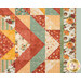 A close up on the patchwork of the quilt, demonstrating fabric color and print details.