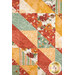A close up on the patchwork of the quilt, demonstrating fabric color and print details.