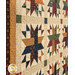 An angled photo of the patchwork stars in the center of the quilt, showcasing fabric, cornernstone block, and border details.