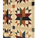 An angled photo of the patchwork stars in the center of the quilt, showcasing fabric, cornernstone block, and stitching details.