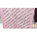 A super close up on the side of the pink tote bag, showing diagonal stripes of quilting themed phrases.