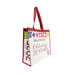 The Shabby Fabrics 20th anniversary tote bag, showing details on the rainbow patchwork block design, red handles, and text graphic, isolated on a white background.