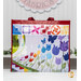 The Shabby Fabrics 20th anniversary tote bag, showing details on the side with a close up on the rainbow colored Blooming Butterflies Quilt, staged on the Shabby Fabrics video set.