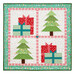 The completed Pieceful Patchwork - December wall hanging depicting Christmas trees and presents in red, blue, green, and white fabrics, isolated on a white background.