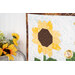 A super close up on one of the yellow sunflowers, demonstrating fabric color and print details as well as top quilting effects.