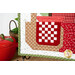 A super close up on the red and white picnic patchwork of the picnic basket, demonstrating fabric color and print details as well as top quilting effects.