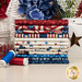 A stack of the fabrics included in the Stars & Stripes 14 FQ set, with flowers and a star and a tin and a jar and buttons and thread.