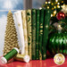 A stack of the fabrics included in the O'Christmas Tree - Green collection, with trees and lights and a window and snow and thread. 