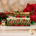 A stack of the fabrics included in the Deck the Halls collection, with a poinsettia and holly and ornaments.