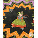 A super close up angled shot of the folded star center, showcasing the black fabric with a witch and her cat.