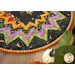 A shot of the outer edge of the table topper, demonstrating fabric, piecing, stitching, prairie point, and binding details.