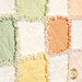 A super close up on one of the quilt blocks, demonstrating details on the fabric, top quilting, and the frayed rag seams of the project.