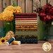 A stack of the fabrics included in the Every Heart Beats True collection, with flowers and jars and a vase and thread.