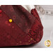 An up close image of the deep red and maroon fabrics used in the project and a gold pin demonstrating use of the product