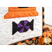 A super close up on one of the purple and black candy blocks, showing fabric colors and top stitching details.