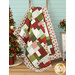 The completed Easy as ABC quilt in red, green, aqua, and cream fabrics from the Make it Merry collection by Marcus Fabrics, artfully draped over a wooden ladder and staged with coordinating flowers and holiday furniture.
