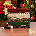 A stack of the fabrics included in the Poinsettias at Chrismas collection, with a christmas tree and ornaments and a fireplace and poinsettias and thread.