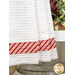 A super close up on the bottom of the hanging towel, demonstrating fabric colors and print details on the striped fabric strip running through the bottom.
