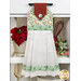 The completed hanging towel staged on a kitchen drawer, colored in cream, mint green, and red fabrics from the Make it Merry collection. Coordinating red decor peeks in from behind the towel.