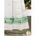 A super close up on the bottom of the hanging towel, demonstrating fabric colors and print details on the striped fabric strip running through the bottom.