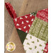 A close up shot of the top of the stocking, showcasing patchwork and the small loop to hang the stocking.