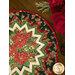 A close up on the outer edge of the topper, showcasing the finished project displayed with poinsettia flowers in the top right corner.
