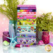 A stack of the colorful fabrics included in the Floral Reef FQ Bundle, with plants and jars and shells and a starfish and thread.