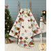 A shot of the quilt draped over a wooden ladder with coordinating festive décor, showcasing the geometry of the design.