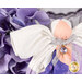 Detail shot of the angel, highlighting the metallic effect of the wings and the angel's metallic silver bow featuring a lavender purple charm that resembles an amethyst in a golden setting.