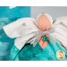 Detail shot of the angel, highlighting the metallic effect of the wings and the angel's metallic silver bow featuring a bright turquoise charm that resembles an aquamarine in a golden setting.