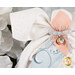 Detail shot of the angel, highlighting the metallic effect of the wings and the angel's metallic silver bow featuring a silver charm that resembles a diamond in a golden setting.