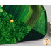 An up close image of the emerald green fabrics used in the project and a gold pin demonstrating use of the product