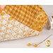 An up close image of the ocher and gold fabrics used in the project and gold pins demonstrating use of the product