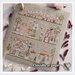 A image of the completed Spring in the city cross stitch pattern staged with coordinating decor.