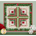 The completed Log Cabin Wall Hanging colored in cream, green, and red Christmas fabrics from the Mistletoe & Holly collection, hung on a mint paneled wall and staged with coordinating Christmas decor.