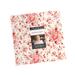 A photograph of the Layer Cake with a black Moda tag and an image of the fabric designer