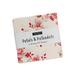 A photograph of the Jelly Roll with a white label and Moda tag saying the name of the collection
