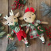 Image of the completed reindeer stuffies on a rustic wood background.