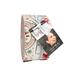 A roll of Christmas themed fabric stripes tied with a ribbon, featuring a tag with photo and branding.