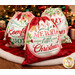 Set of three festive Christmas gift bags with red and green holiday designs, stuffed and staged under a Christmas tree.