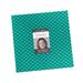 Square precuts with a picture of the designer, the name 