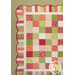 A super close up on the upper left corner of the quilt, demonstrating details on the fabric colors and scalloped border.