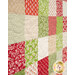 An angled close up of the patchwork of the project, demonstrating fabric colors and print details.