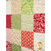 An angled close up of the patchwork of the project, demonstrating fabric colors and print details.