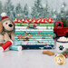 A stack of the fabrics included in the Winter Waggers collection, with trees and snow and a red truck with a tree and a mug and a plush dog and a dog bisuit and greenery and thread.