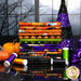 A stack of the fabrics included in the Spooky Tails collection, with a witch's hat and a cat and pumpkins and thread.