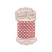 Spool of ivory fabric with an bright red gingham print bias tape isolated on a white background